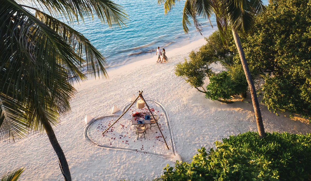 Couple walking on the Kandima Maldives beach